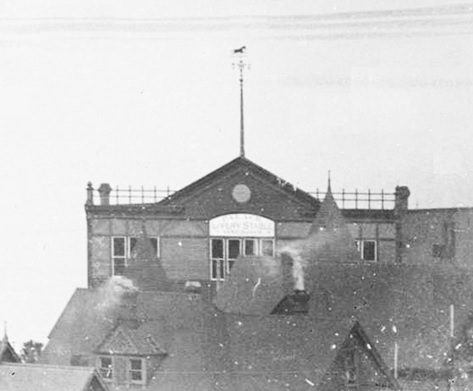 Palace Livery Stable, about 1895, detail, View of downtown houses, part of Stanley Park, and the North Shore mountains from the roof of Manor House, Vancouver City Archives, SGN 447; http://searcharchives.vancouver.ca/index.php/view-of-downtown-houses-part-of-stanley-park-and-north-shore-mountains-from-roof-of-manor-house [Note horse on top of weather vane.]